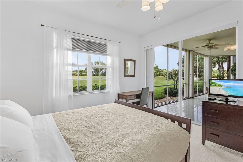 20240 Burnside Place, Unit 1603 Estero, FL 33928 - Photo 25 of 41 a bedroom with a bed and large windows