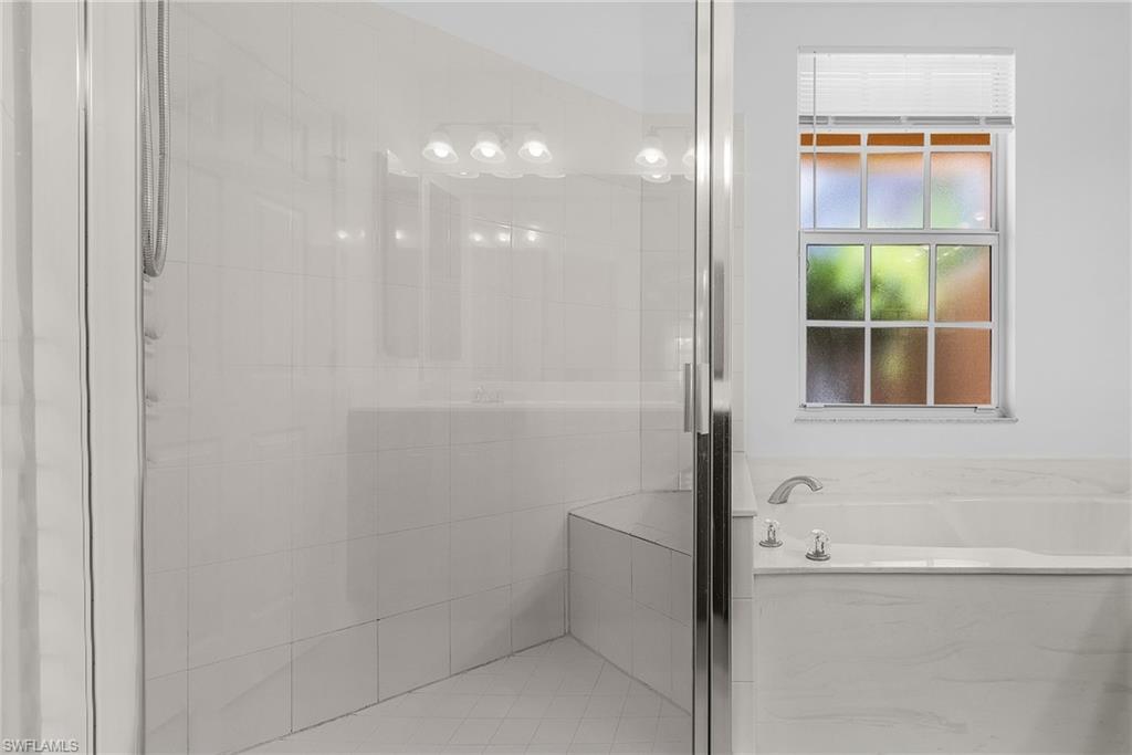 20240 Burnside Place, Unit 1603 Estero, FL 33928 - Photo 26 of 41 a bathroom with a bathtub