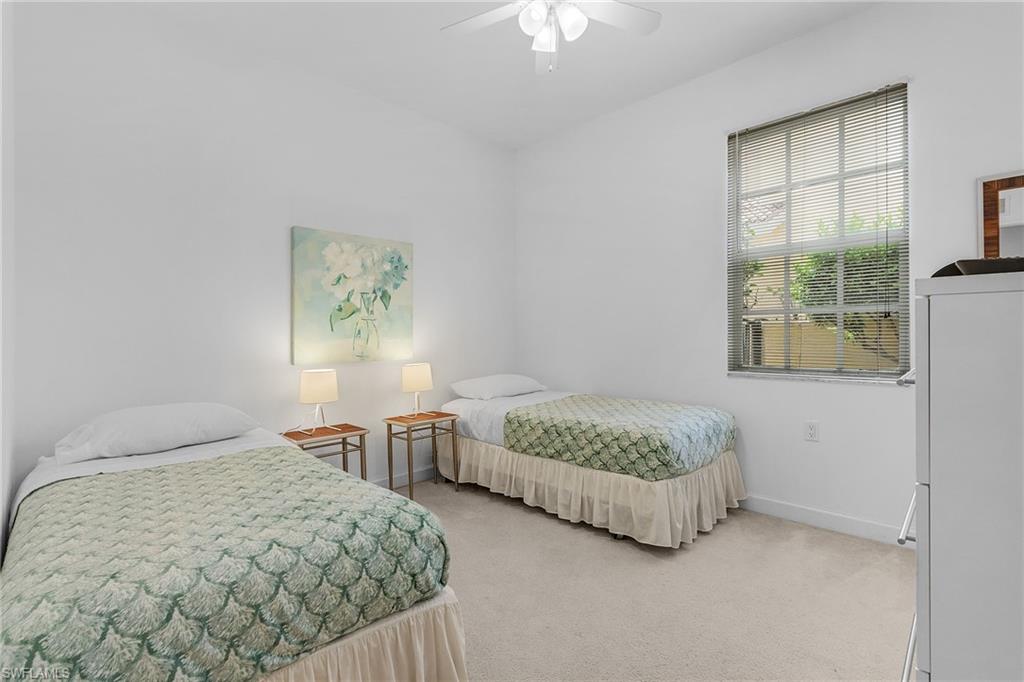 20240 Burnside Place, Unit 1603 Estero, FL 33928 - Photo 28 of 41 a bedroom with two beds and a table
