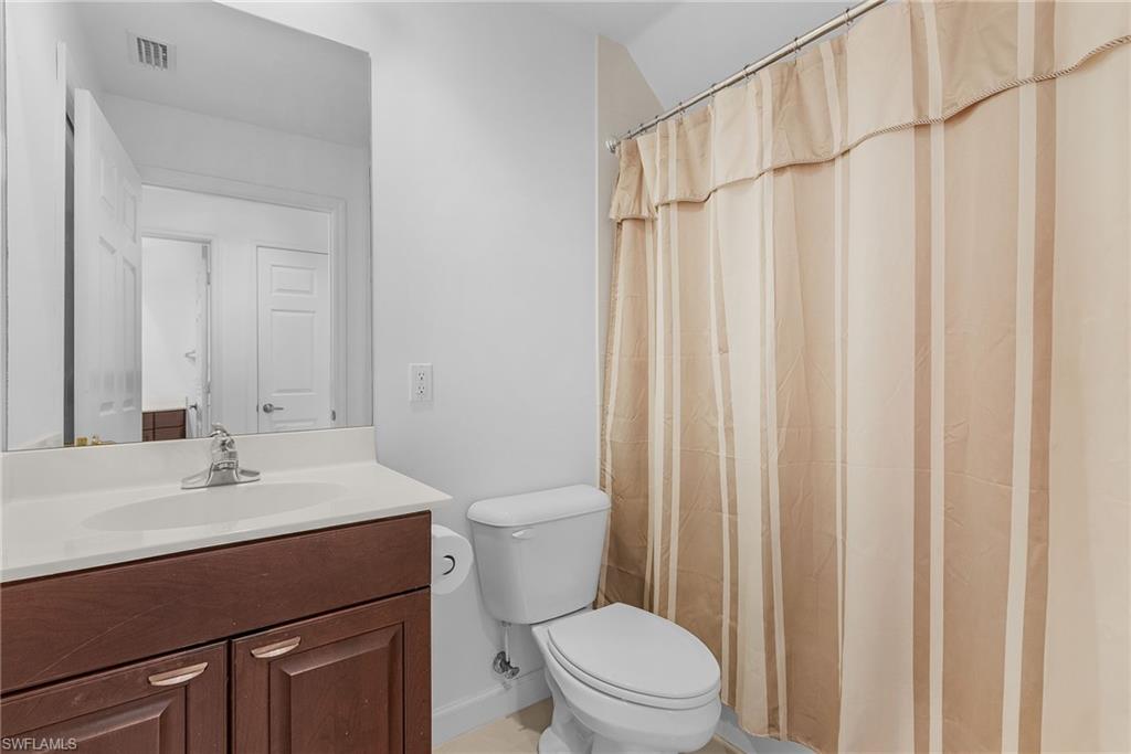 20240 Burnside Place, Unit 1603 Estero, FL 33928 - Photo 29 of 41 a bathroom with a sink a toilet and shower
