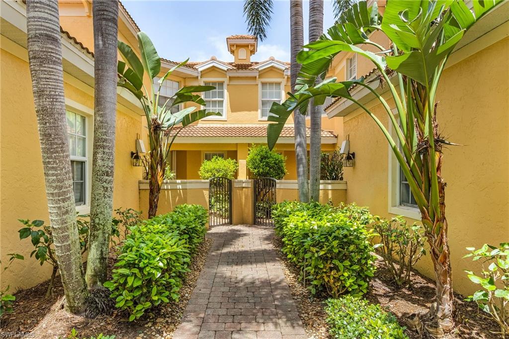 20240 Burnside Place, Unit 1603 Estero, FL 33928 - Photo 3 of 41 a front view of a multi story residential apartment building with a yard