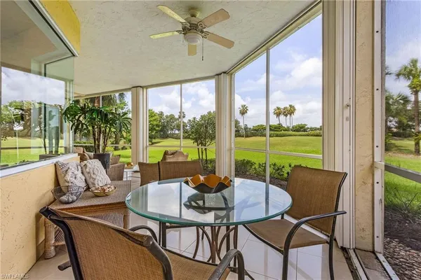 a view of a house with many windows and plants