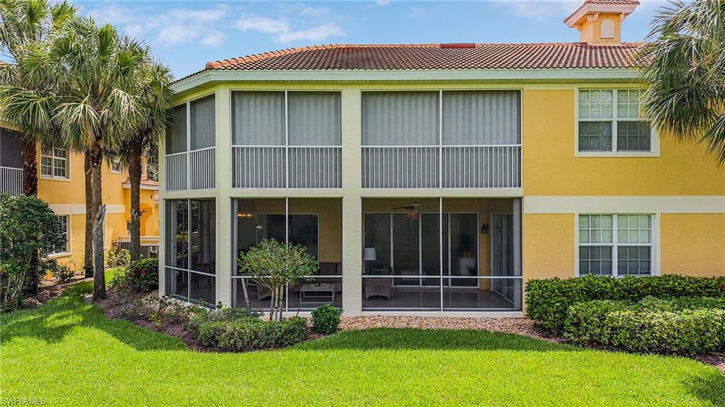 20240 Burnside Place, Unit 1603 Estero, FL 33928 - Photo 35 of 41 a view of a house with many windows and plants