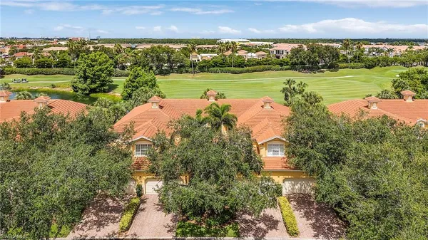 an aerial view of a house with a yard and trees