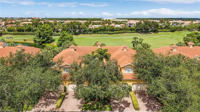 an aerial view of a house with a yard and trees