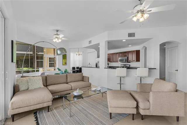a dining room with furniture and a large window