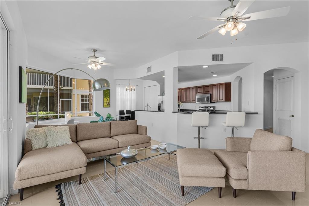 20240 Burnside Place, Unit 1603 Estero, FL 33928 - Photo 10 of 41 a living room with furniture and a large window