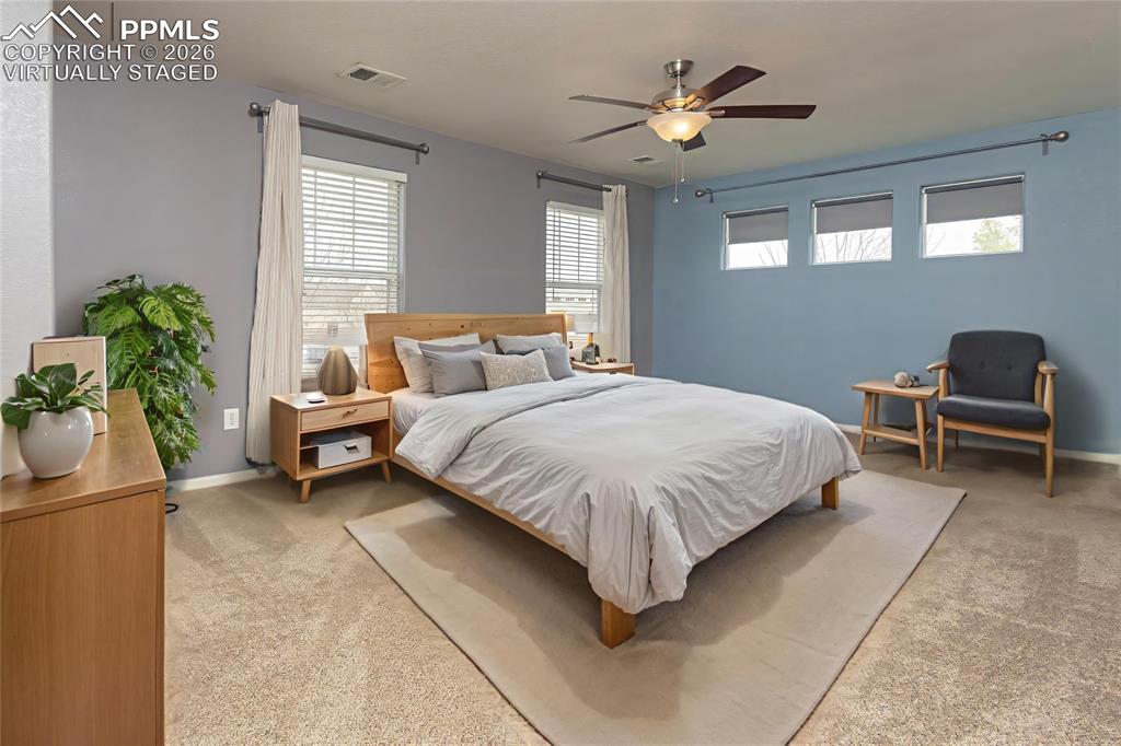 4815 Harrier Ridge Drive Colorado Springs, CO 80916 - Photo 11 of 33 Bedroom featuring a ceiling fan and light carpet Virtually Staged