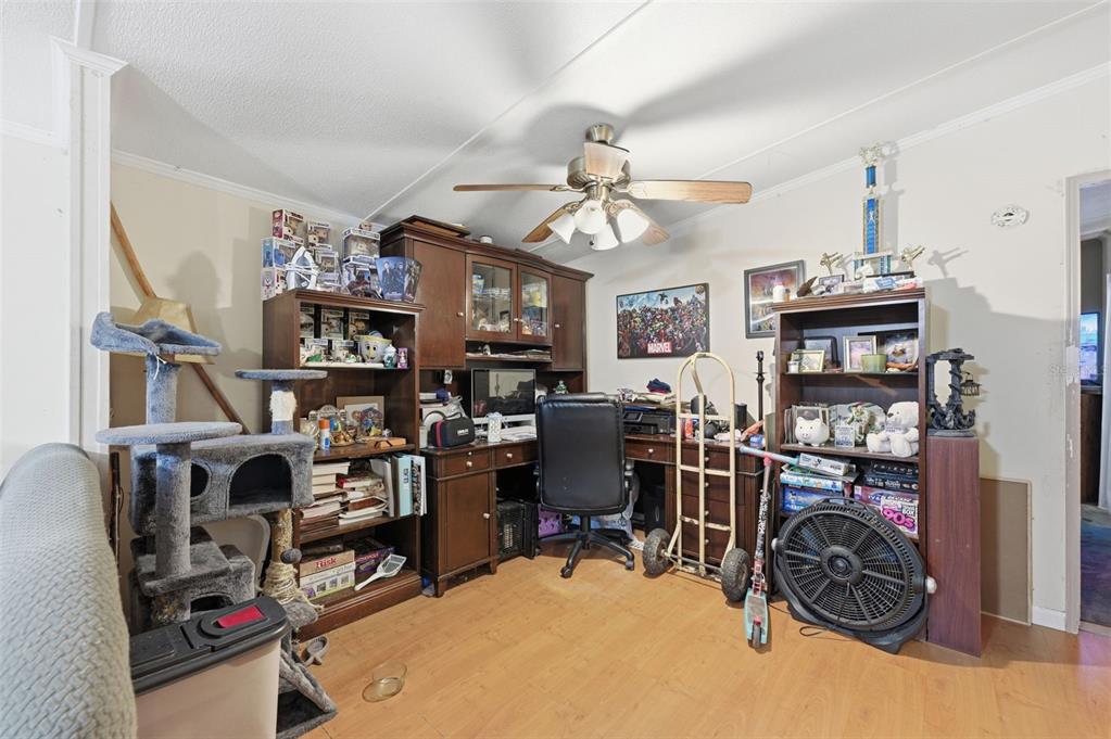 13050 Sun Road Brooksville, FL 34613 - Photo 15 of 47 a view of a workspace with furniture and a living room