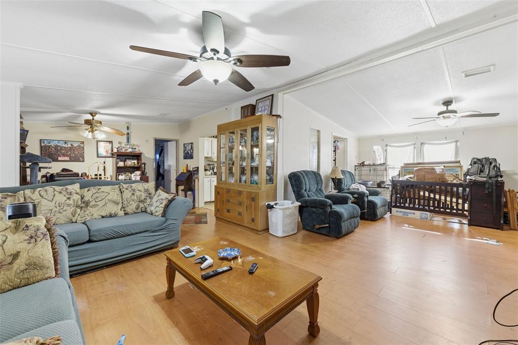 13050 Sun Road Brooksville, FL 34613 - Photo 20 of 47 a living room with furniture ceiling fan and a rug