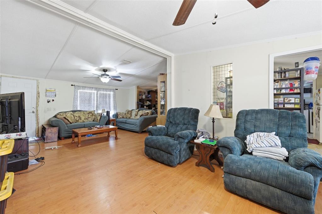 13050 Sun Road Brooksville, FL 34613 - Photo 22 of 47 a living room with furniture and a chandelier