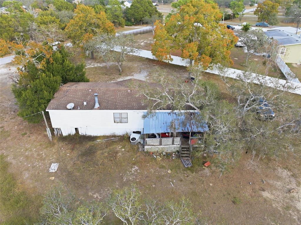 13050 Sun Road Brooksville, FL 34613 - Photo 23 of 47 an aerial view of a house with swimming pool and large trees