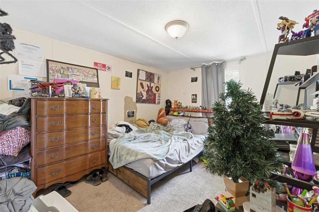 13050 Sun Road Brooksville, FL 34613 - Photo 25 of 47 a bed room with a bed and a couch