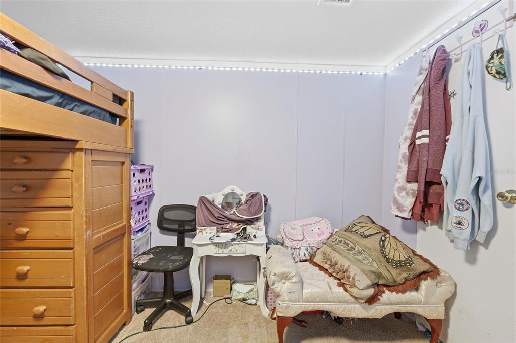 13050 Sun Road Brooksville, FL 34613 - Photo 28 of 47 a view of a bedroom with furniture and clothes