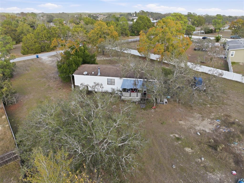 13050 Sun Road Brooksville, FL 34613 - Photo 30 of 47 an aerial view of a house with a yard