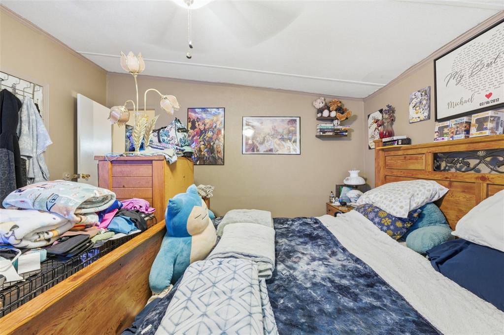 13050 Sun Road Brooksville, FL 34613 - Photo 40 of 47 a bedroom with a bed and furniture