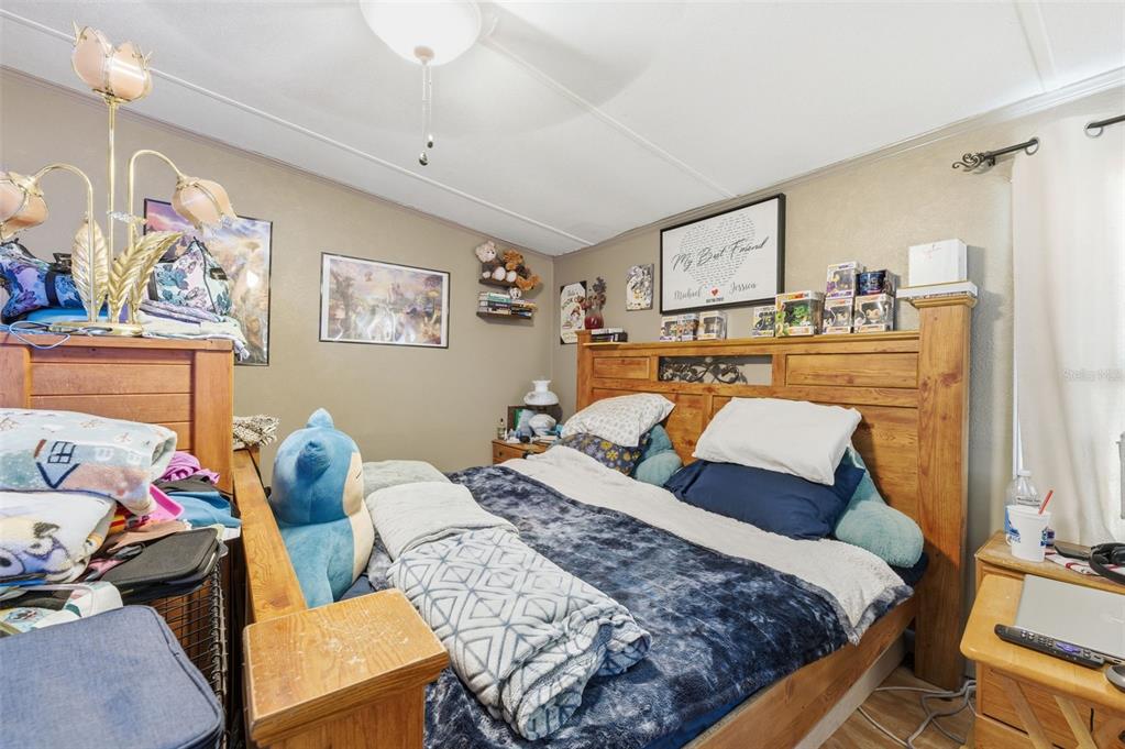 13050 Sun Road Brooksville, FL 34613 - Photo 41 of 47 a bedroom with a bed and wooden floor