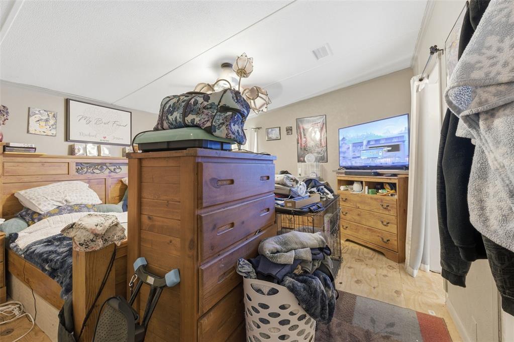 13050 Sun Road Brooksville, FL 34613 - Photo 42 of 47 a bed room with a bed and a mirror