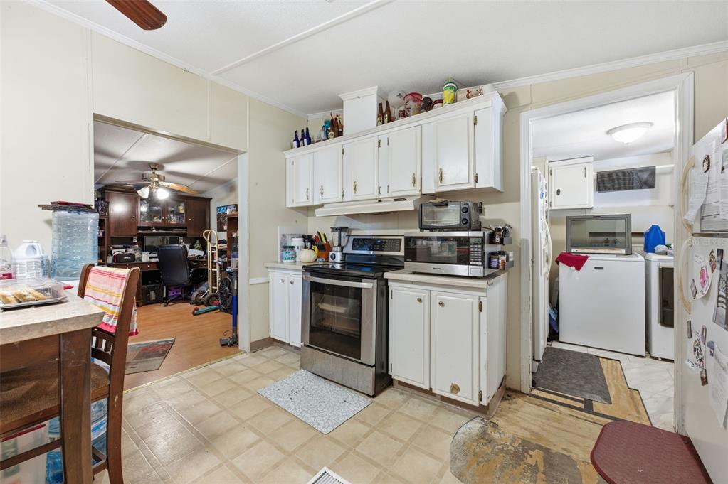 13050 Sun Road Brooksville, FL 34613 - Photo 6 of 47 a kitchen with granite countertop a refrigerator stove top oven and sink