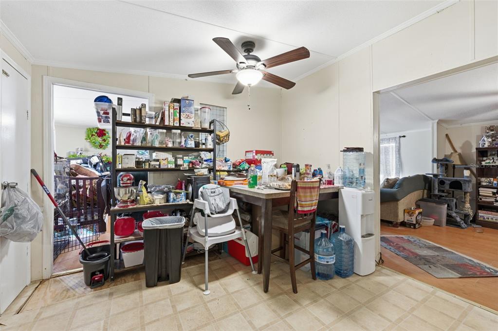 13050 Sun Road Brooksville, FL 34613 - Photo 7 of 47 a dining room filled with lots of furniture and white walls