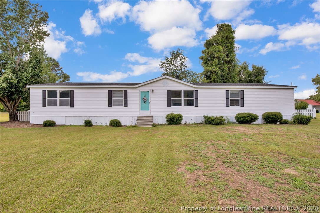 2147 Bainbridge Road Stedman, NC 28391 - Photo 1 of 42 a front view of house with yard and trees