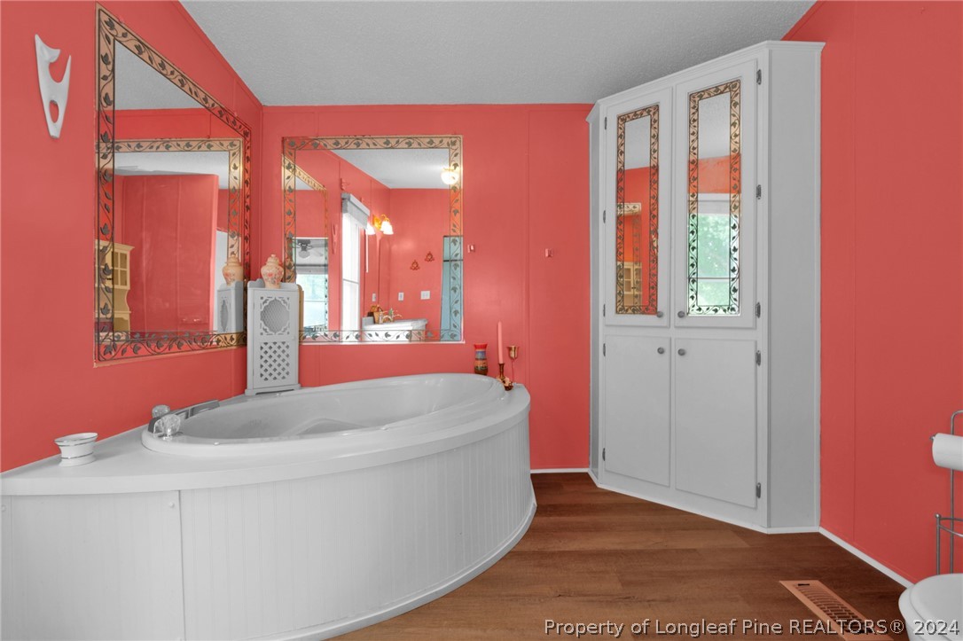 2147 Bainbridge Road Stedman, NC 28391 - Photo 18 of 42 a en suite bathroom with a granite countertop sink and a mirror
