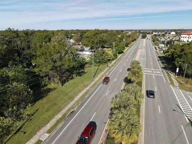 an aerial view of a house with a yard basket ball court and outdoor seating