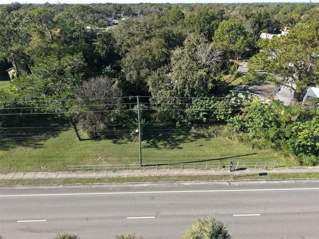 an aerial view of house with yard swimming pool and outdoor seating
