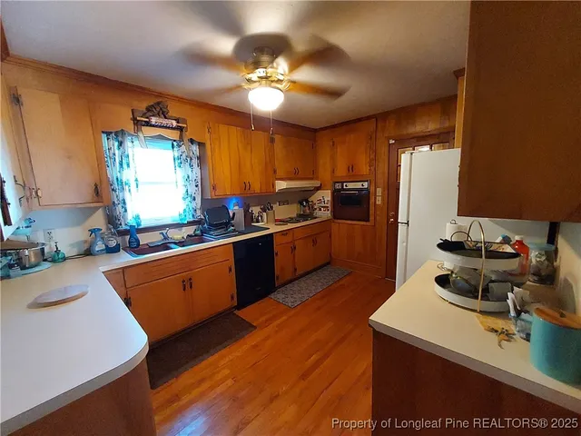 a kitchen with stainless steel appliances a sink stove and refrigerator