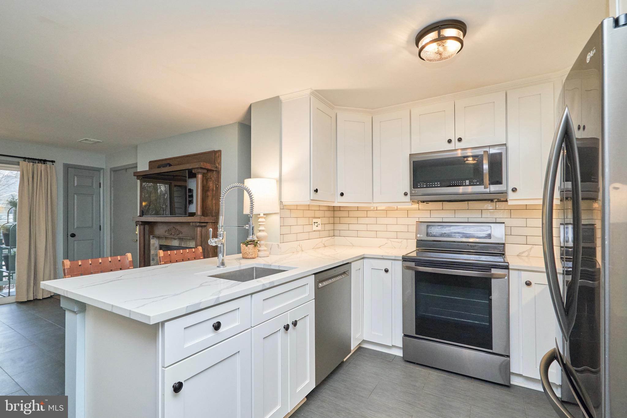 11703 Summerchase Circle Reston, VA 20194 - Photo 16 of 33 White cabinets, quartz counters, undercount lights