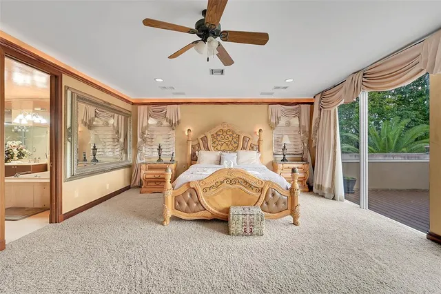 a bedroom with a large bed and a chandelier