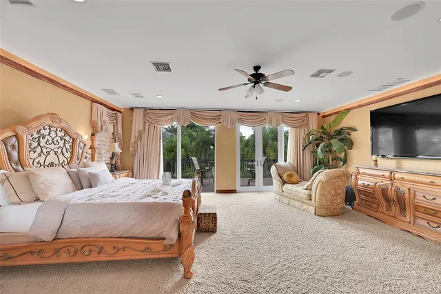 a large bed sitting in a room next to a cabinet