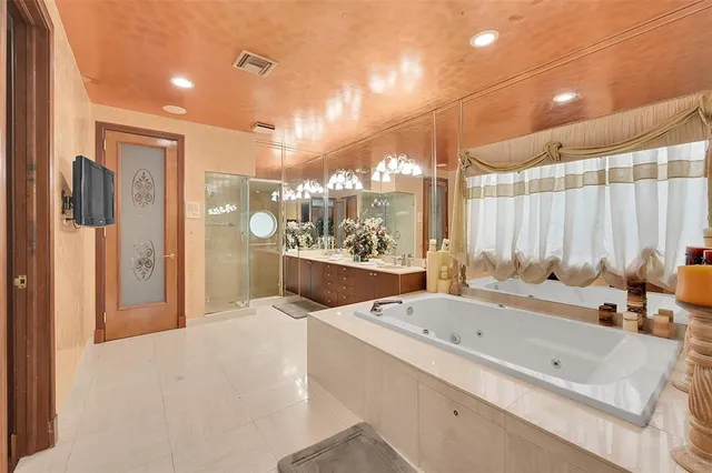 a bedroom with a bed window and a flat screen tv