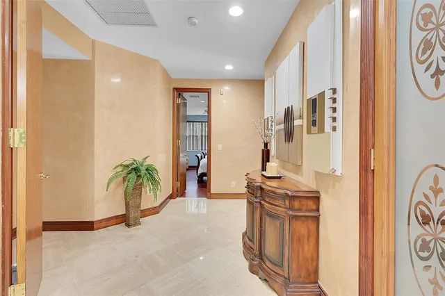 a spacious bedroom with a bed and a chandelier