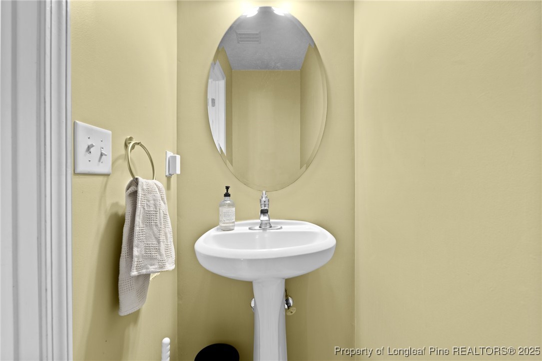 106 Polk Street Spring Lake, NC 28390 - Photo 19 of 47 a bathroom with a sink and a mirror