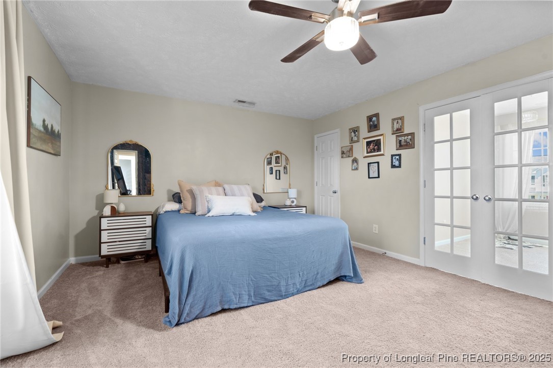 106 Polk Street Spring Lake, NC 28390 - Photo 21 of 47 a bedroom with a large bed and a chandelier