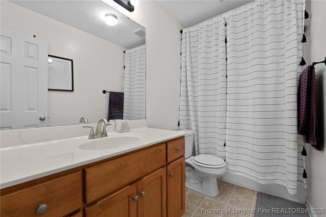 106 Polk Street Spring Lake, NC 28390 - Photo 26 of 47 a bathroom with a sink a toilet and mirror