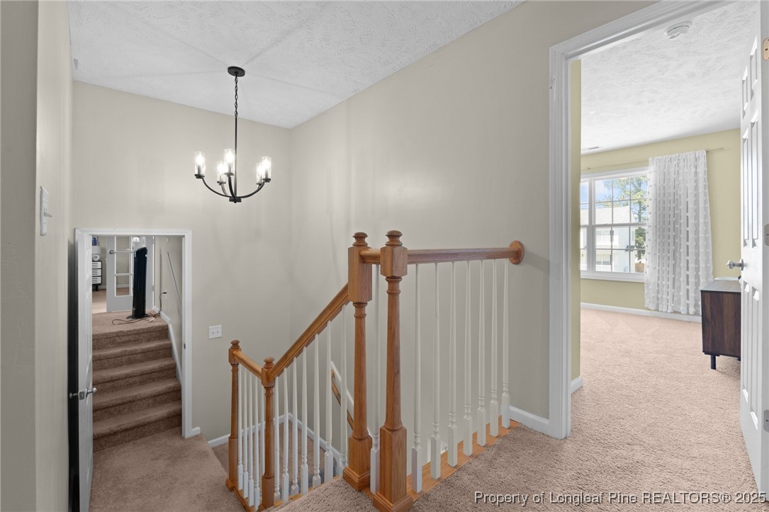 106 Polk Street Spring Lake, NC 28390 - Photo 27 of 47 a view of a hallway with chandelier and stairs