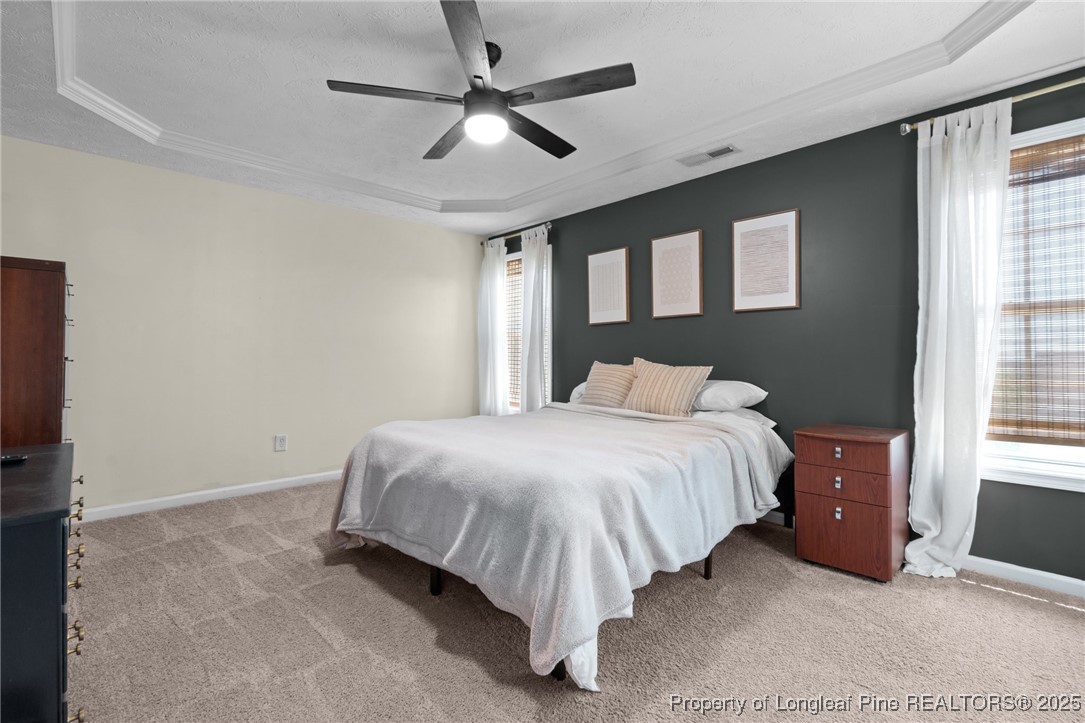 106 Polk Street Spring Lake, NC 28390 - Photo 31 of 47 a bedroom with a bed and a ceiling fan