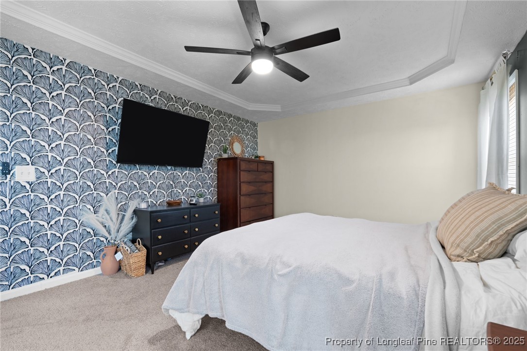 106 Polk Street Spring Lake, NC 28390 - Photo 32 of 47 a bedroom with a bed and a flat screen tv