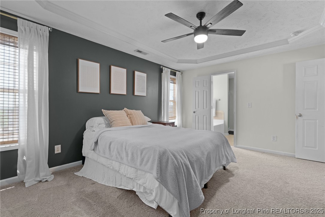 106 Polk Street Spring Lake, NC 28390 - Photo 33 of 47 a bedroom with a bed and a ceiling fan