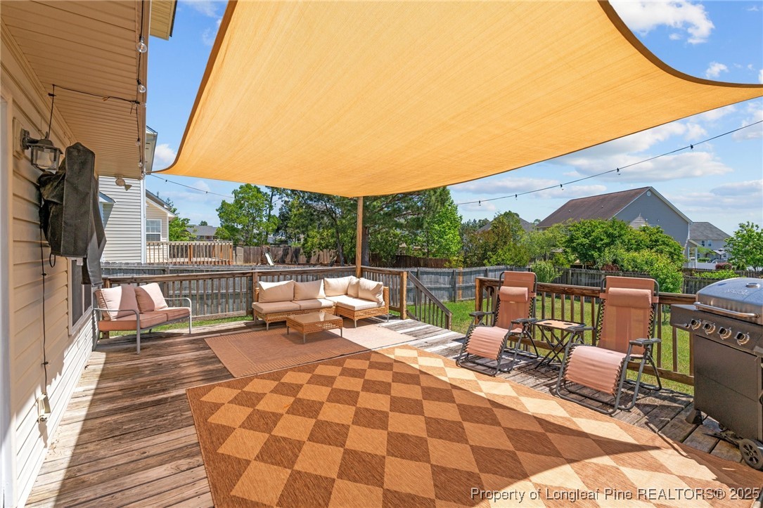 106 Polk Street Spring Lake, NC 28390 - Photo 41 of 47 a view of roof deck with a barbeque and wooden stairs