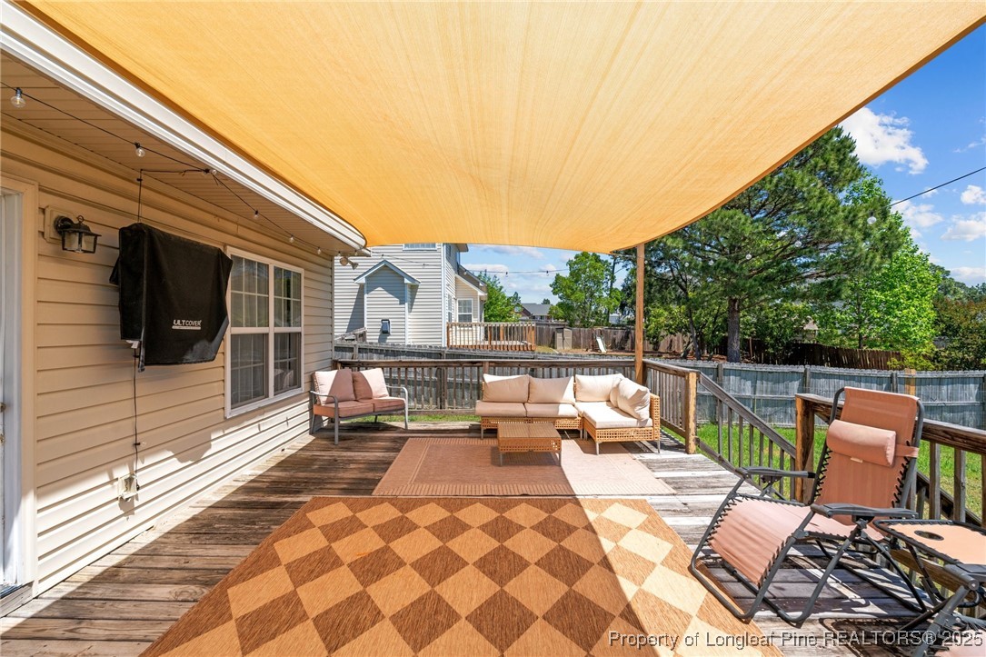 106 Polk Street Spring Lake, NC 28390 - Photo 42 of 47 a view of balcony with wooden floor and outdoor seating