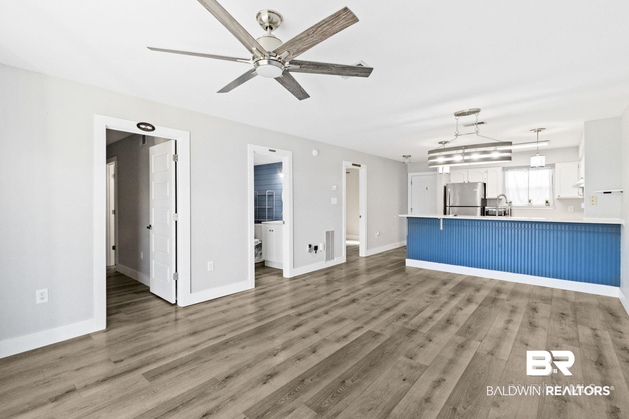 25861 Canal Road, Unit 77 Orange Beach, AL 36561 - Photo 13 of 48 Unfurnished living room featuring light wood-style floors and ceiling fan