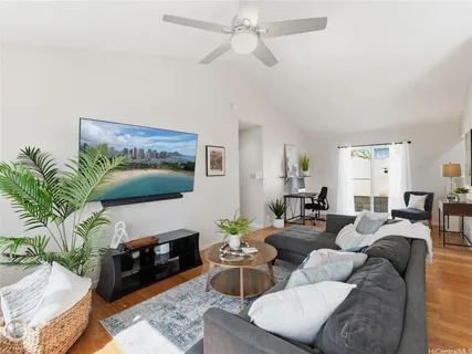 a living room with furniture a fireplace and a flat screen tv