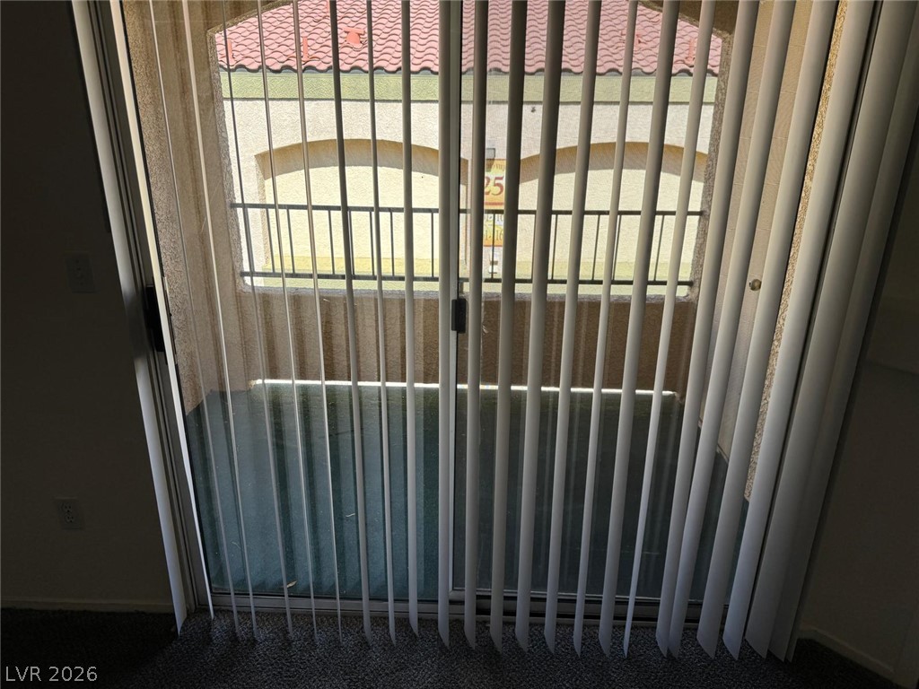 7885 West Flamingo Road, Unit 2171 Las Vegas, NV 89147 - Photo 9 of 22 The balcony offers a pleasant outdoor retreat with decorative railing and privacy blinds.