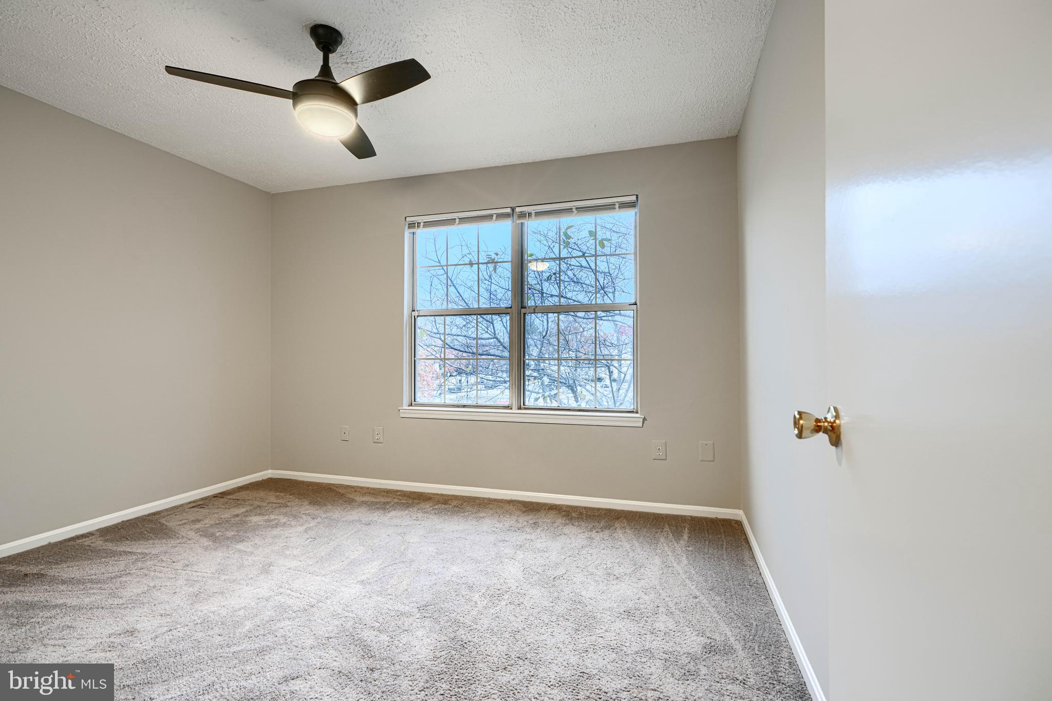 14905 Cleese Court, Unit 5AF Silver Spring, MD 20906 - Photo 20 of 30 an empty room with a window and a fan