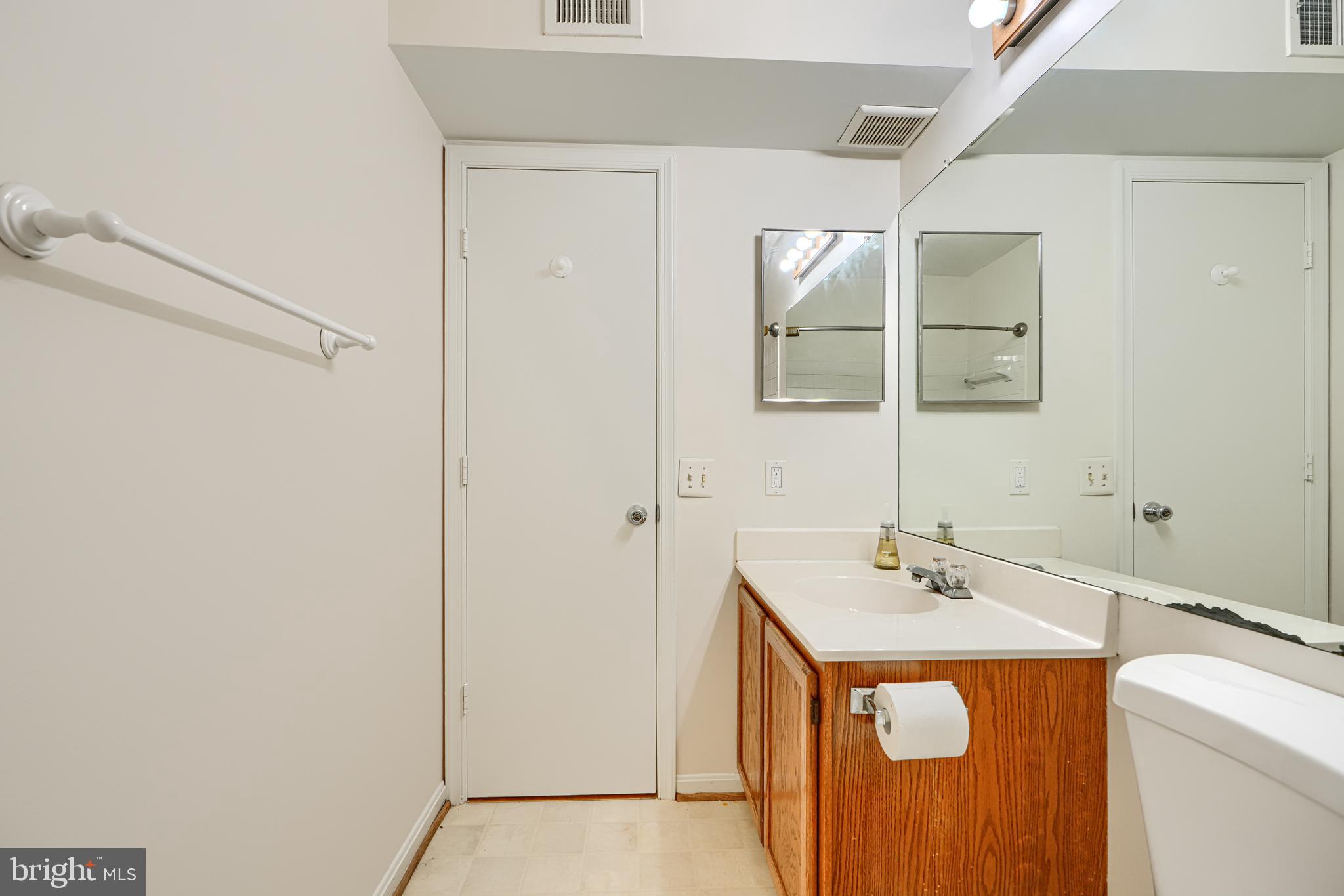 14905 Cleese Court, Unit 5AF Silver Spring, MD 20906 - Photo 25 of 30 a bathroom with a sink and a mirror