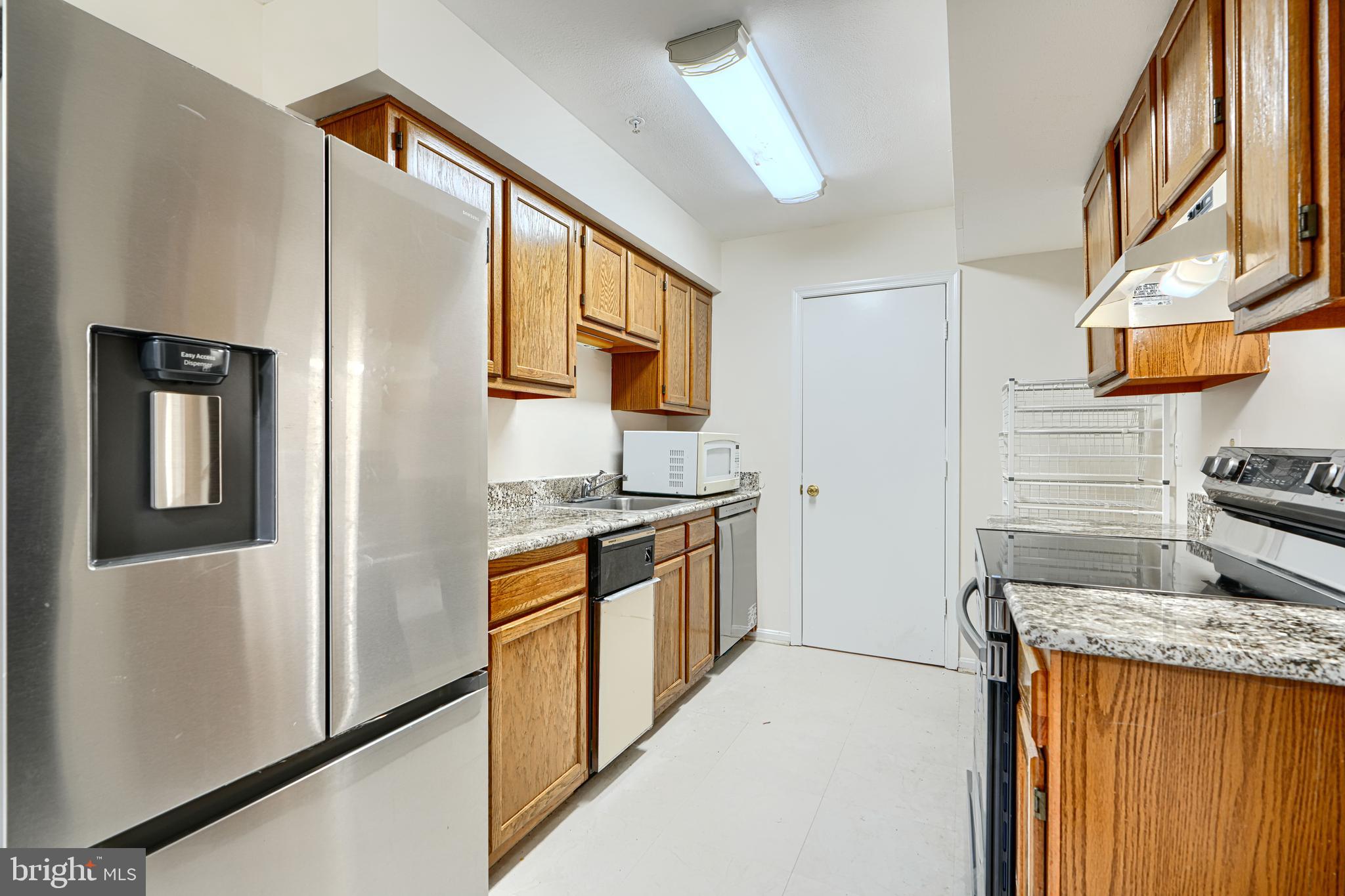 14905 Cleese Court, Unit 5AF Silver Spring, MD 20906 - Photo 4 of 30 a kitchen with stainless steel appliances granite countertop a refrigerator and a stove
