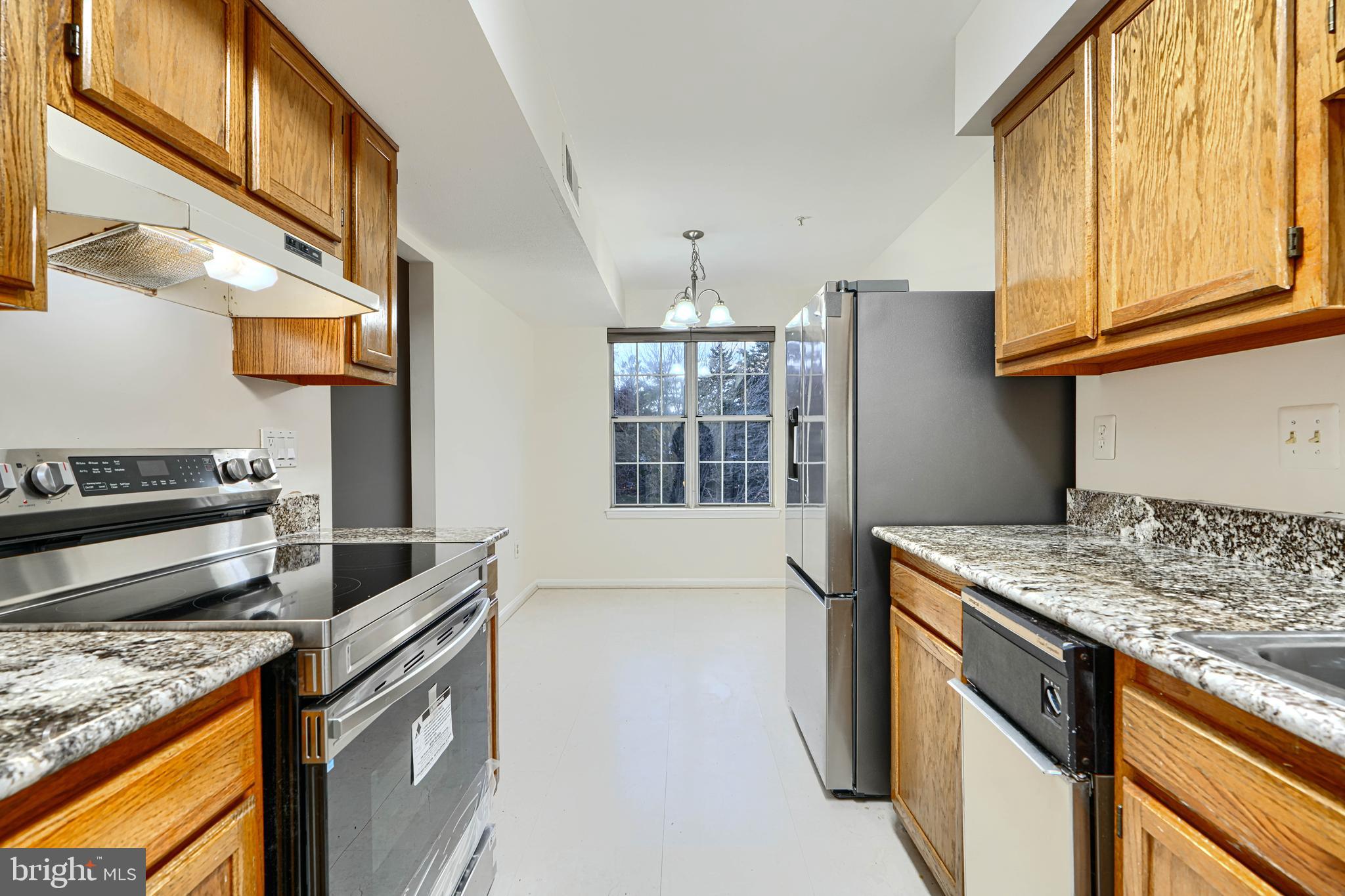 14905 Cleese Court, Unit 5AF Silver Spring, MD 20906 - Photo 5 of 30 a kitchen that has a sink a stove and a microwave